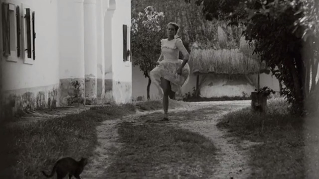 1945 - Rozsi Dora Sztarenki running down lane towards tabby cat