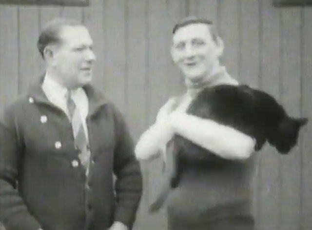 Alex Ireland in Training - holding large black cat