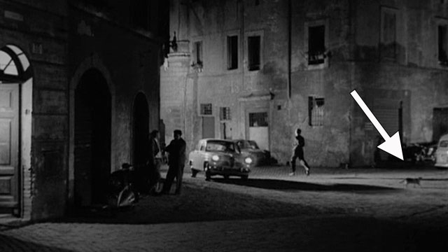 Un Amore a Roma - Love in Rome - Marcello Peter Baldwin running on street with bicolor cat nearby