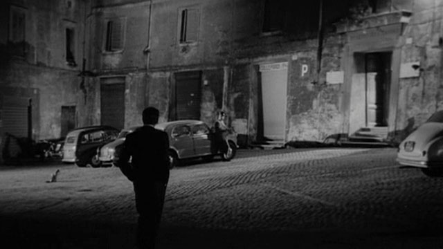 Un Amore a Roma - Love in Rome - Marcello Peter Baldwin walking on street with bicolor cat nearby