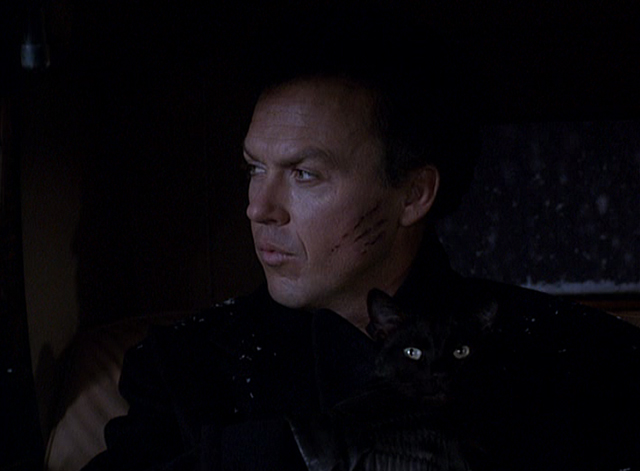 Batman Returns - Bruce Wayne Michael Keaton holding black cat in back of car