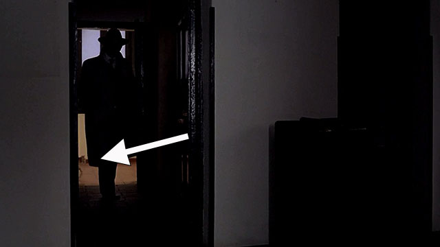 Beltenebros - Prince of Shadows - tabby cat walking across doorway behind Darman Terence Stamp