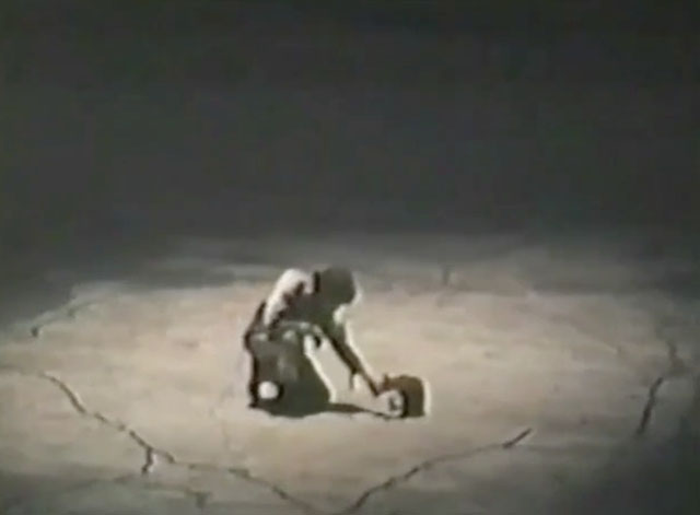 Between Time and Timbuktu - Stony Stevenson William Hickey on empty dry mud flat with cat