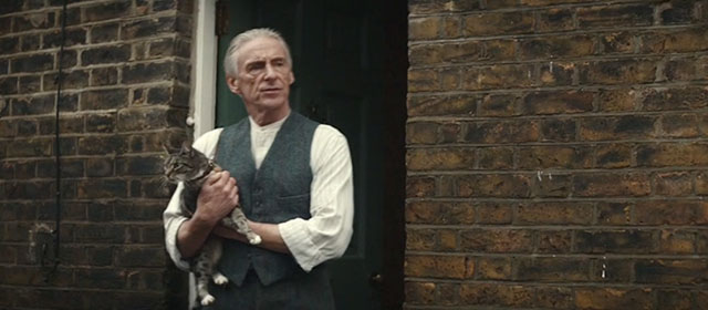 Blitz - brown tabby cat Olly held by Gerald Paul Weller outside home