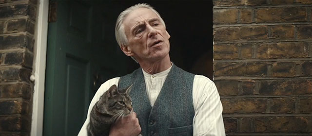 Blitz - brown tabby cat Olly held by Gerald Paul Weller outside home