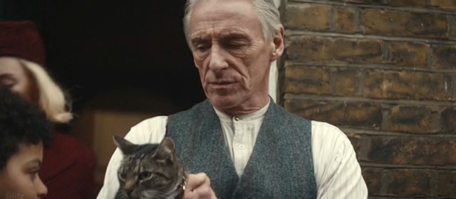 Blitz - brown tabby cat Olly held by Gerald Paul Weller outside home with George Elliott Heffernan