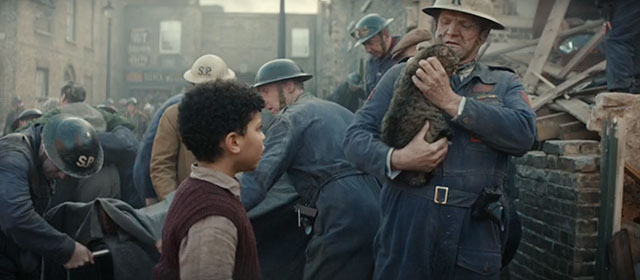 Blitz - brown tabby cat Olly carried from destroyed home by air raid warden Tim Faraday with George Elliott Heffernan