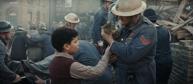 Blitz - brown tabby cat Olly carried from destroyed home by air raid warden Tim Faraday with George Elliott Heffernan