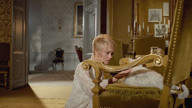 Bluebeard - Anne Joey Heatherton petting white cat on chair