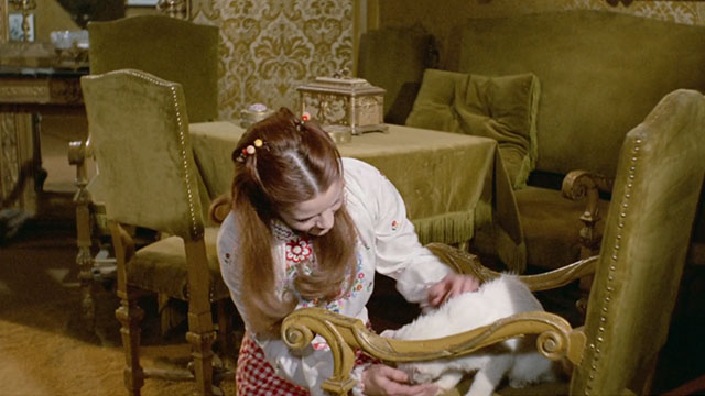 Bluebeard - Caroline Agostina Belli petting white cat on chair