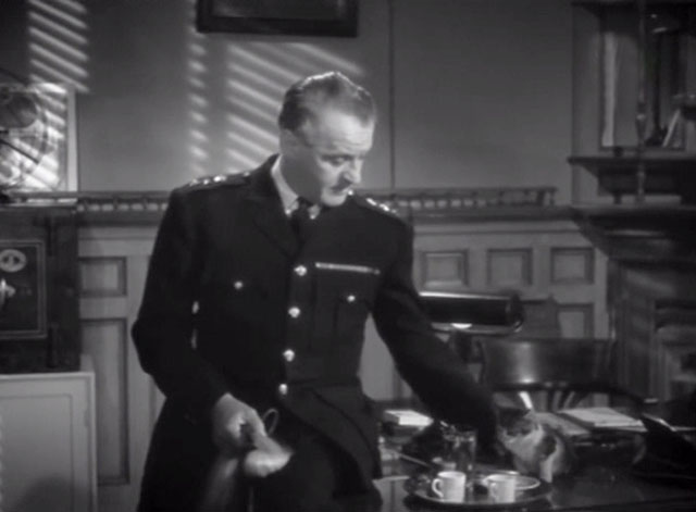 Cairo Road - Colonel Bey Eric Portman petting tiny tabby kitten at desk