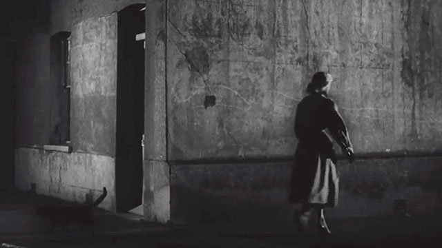 Cat Girl - Dorothy Kay Callard walking past black cat on dark street