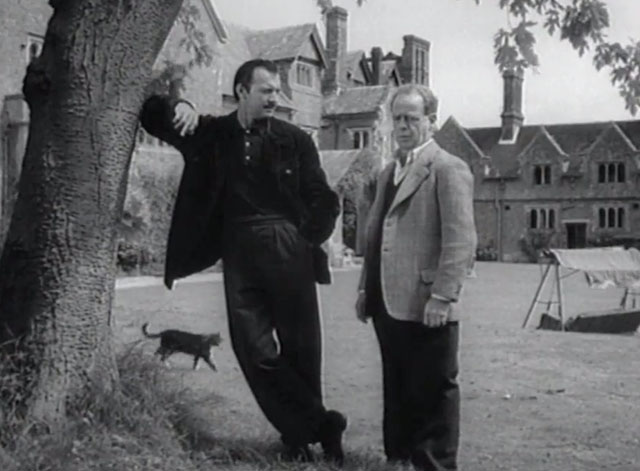 The Counterfeit Plan - tabby and white cat walking behind Mervyn Jones and Zachary Scott on lawn