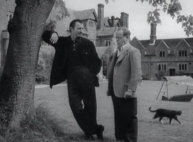 The Counterfeit Plan - tabby and white cat walking behind Mervyn Jones and Zachary Scott on lawn