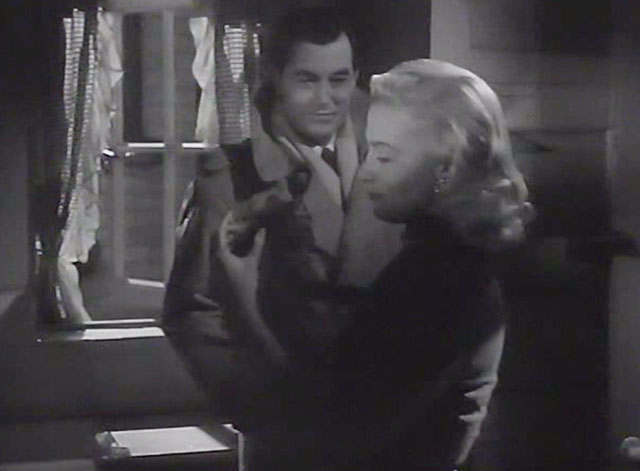 Desperate Moment - Anna Mai Zetterling holding tiny tabby kitten in dark kitchen with Sawyer Philip Friend