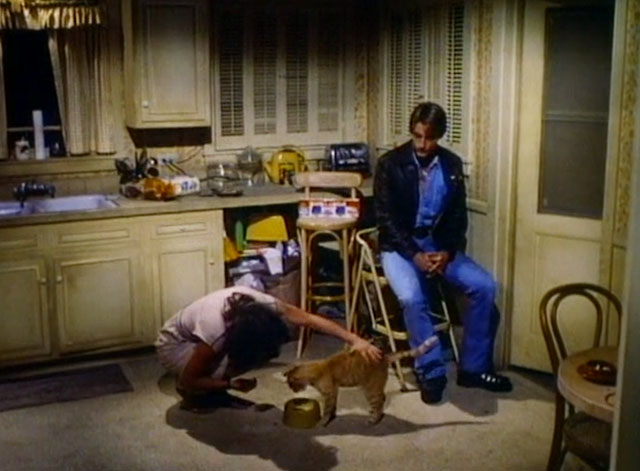 A Different Story - Stella Meg Foster feeding ginger tabby cat Chuck on floor with Albert Perry King