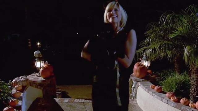 The Dog Who Saved Halloween - Monique Kristen Miller outside house holding black cat Rufus Inky