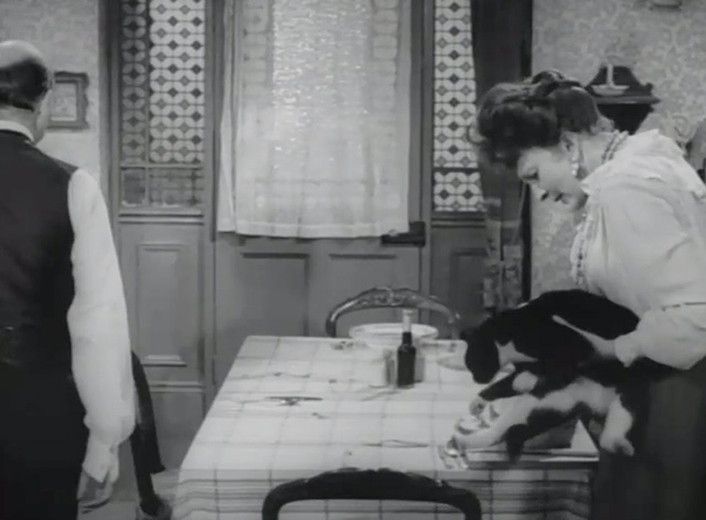 Dr. Crippen - Crippen Donald Pleasance walking away as wife Belle Coral Browne sets tuxedo cat on chair