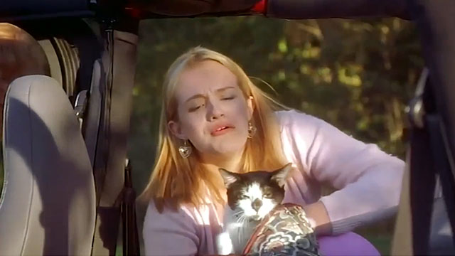 Earthly Possessions - Mindy Elisabeth Moss taking tuxedo cat Murder out of bag