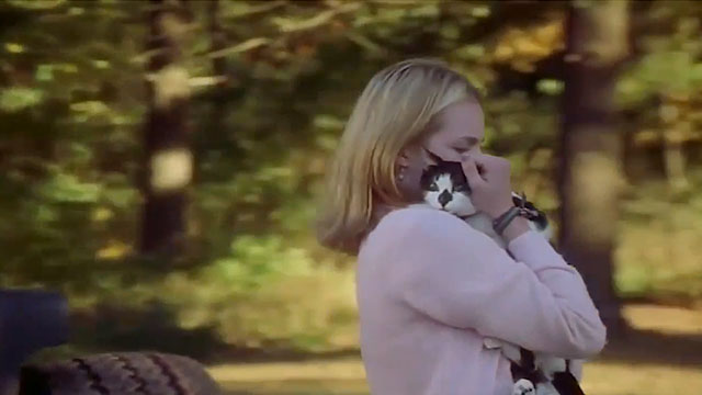 Earthly Possessions - Mindy Elisabeth Moss holding tuxedo cat Murder