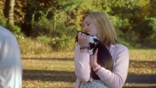 Earthly Possessions - Mindy Elisabeth Moss holding tuxedo cat Murder