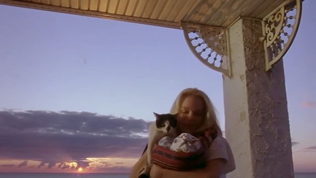 Earthly Possessions - Mindy Elisabeth Moss holding baby and tuxedo cat Murder