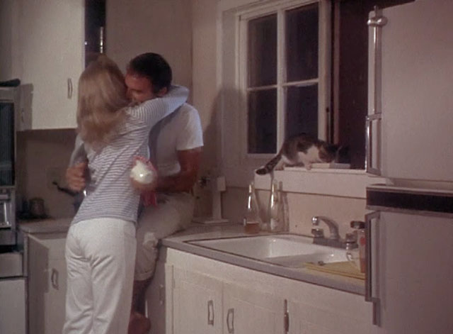 Fade In - Rob Burt Reynolds and Jean Barbara Loden in kitchen with tabby and white cat eating on windowsill