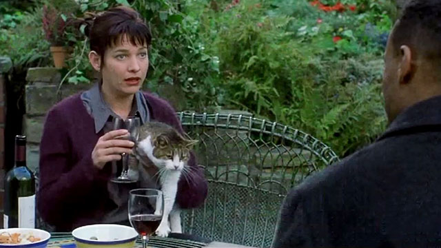 Fanny and Elvis - erry Fox holding tabby and white cat Blossom at table with Alan Colin Salmon