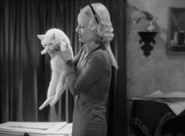 Fashions of 1934 - Lynn Bette Davis picking up white cat from drawing table