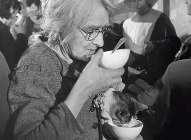 Forbidden Games - cat in woman's arms eating from cup