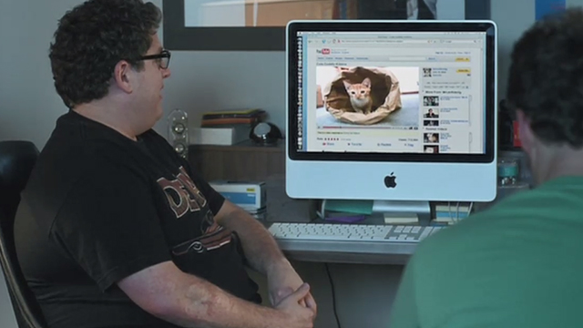 Funny People - Leo Jonah Hill looking at orange tabby kitten in bag on computer screen