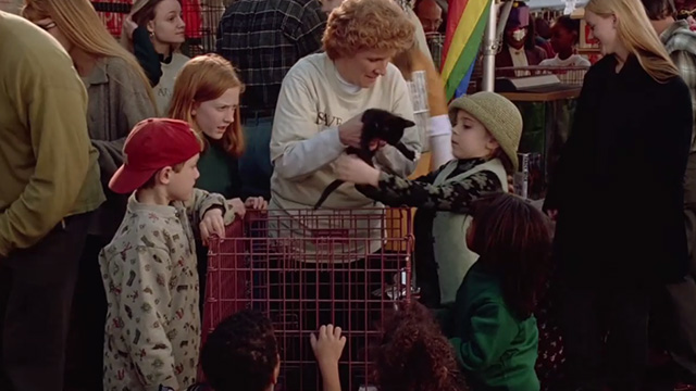 The Gingerbread Man - Libby Mae Whitman taking tuxedo kitten from woman