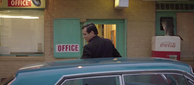 Green Book - gray and white tabby Bebe on Coke machine in background behind Tony Viggo Mortensen