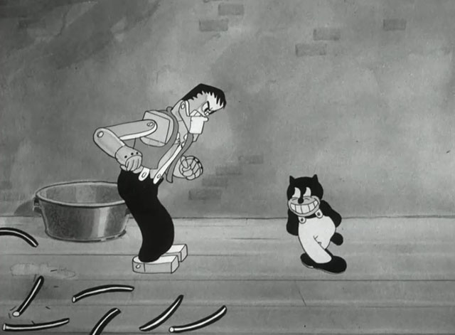 Hollywood Capers - Looney Tunes cartoon black cat Beans looking innocent as Frankenstein's monster breaks free