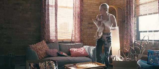 Hustlers - Annabelle Lili Reinhart picking up orange and white tabby cat