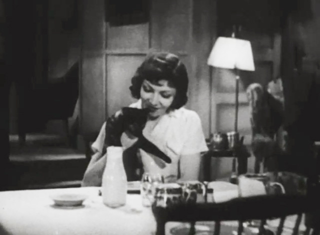 I Cover the Waterfront - Julie Claudette Colbert at table with tortoiseshell cat