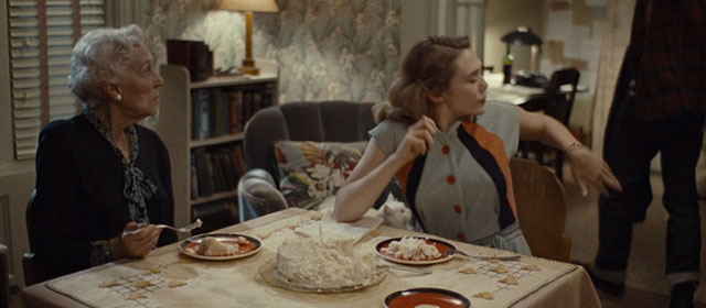 Kill Your Darlings - longhair white cat Kit Kat on chair behind Edie Elizabeth Olsen and grandmother