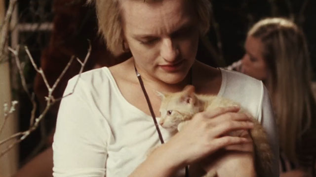 Listen Up Philip - Ashley Elisabeth Moss holding ginger tabby kitten