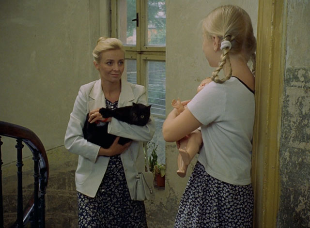 Little Otik - black cat Mikeš held by Bozena Veronika Zilková on stairs with Alzbetka Kristina Adamcová