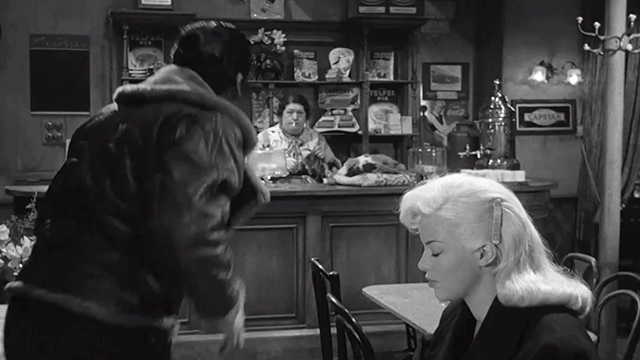 The Long Haul - Harry Victor Mature and Lynn Diana Dors sitting at table with woman and large calico cat behind counter in background