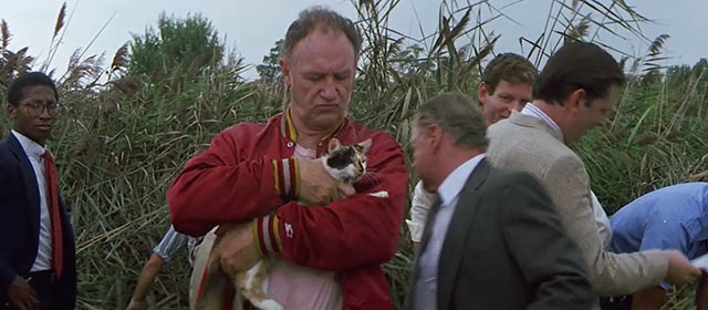 Loose Cannons - Mac Gene Hackman in swamp carrying calico cat Camus