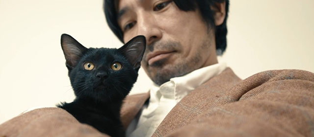 Mad Cats - Mune So Yamanaka holding black kitten