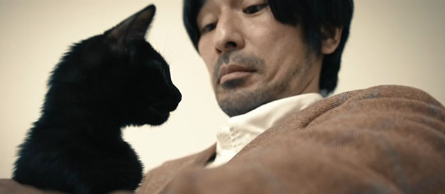 Mad Cats - Taka Shô Mineo with Mune So Yamanaka holding black kitten in white void
