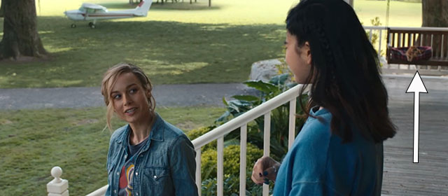 The Marvels - Carol Captain Marvel Brie Larson and Kamala Iman Vellani on porch with ginger tabby cat Flerken Goose in background