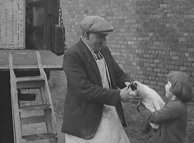 Moving a Farm - little girl handing white and black cat to moving man