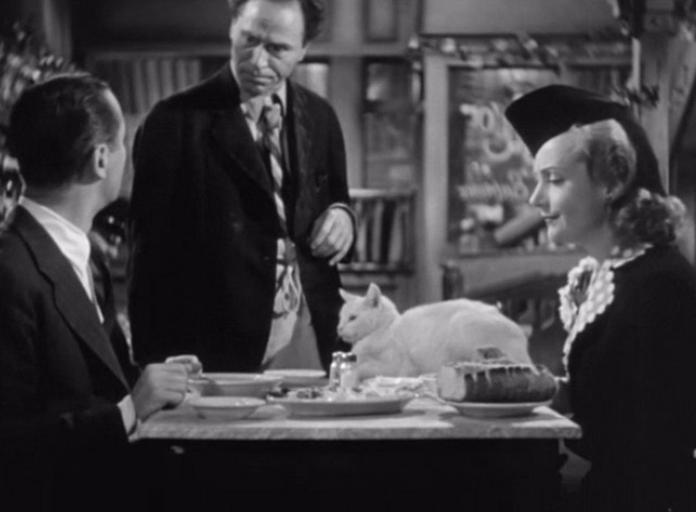 Mr. and Mrs. Smith - Proprietor William Edmunds with David Robert Montgomery and Ann Carole Lombard with white cat on table with 