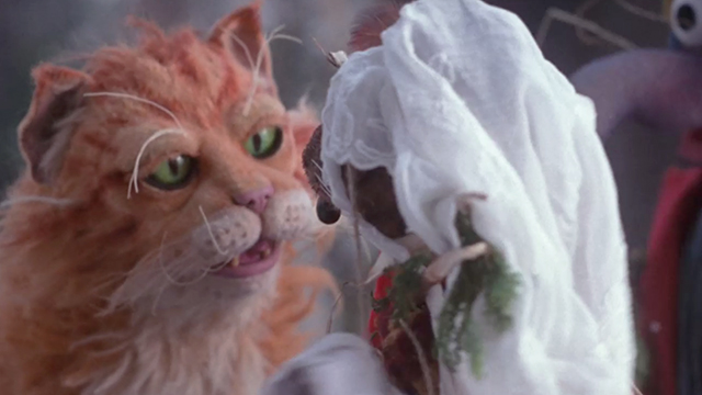 The Muppet Christmas Carol - orange and white tabby Muppet cat behind Rizzo the Rat