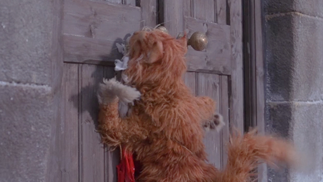 The Muppet Christmas Carol - orange and white tabby Muppet cat slammed up against door