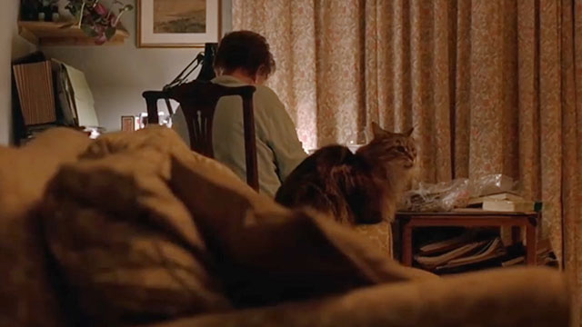 Notes on a Scandal - longhair brown tabby cat Portia sitting near Barbara Judi Dench
