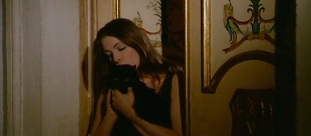 Nuda per Satana - Nude for Satan - Susan Rita Calderoni holding longhair black cat outside door